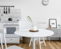 Kitchenette with white, round, dining table and two white chairs