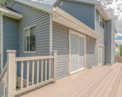 Square frame Modern two storey home with unfinished deck area. An under construction deck on a modern two storey home on a sunny, clear day.