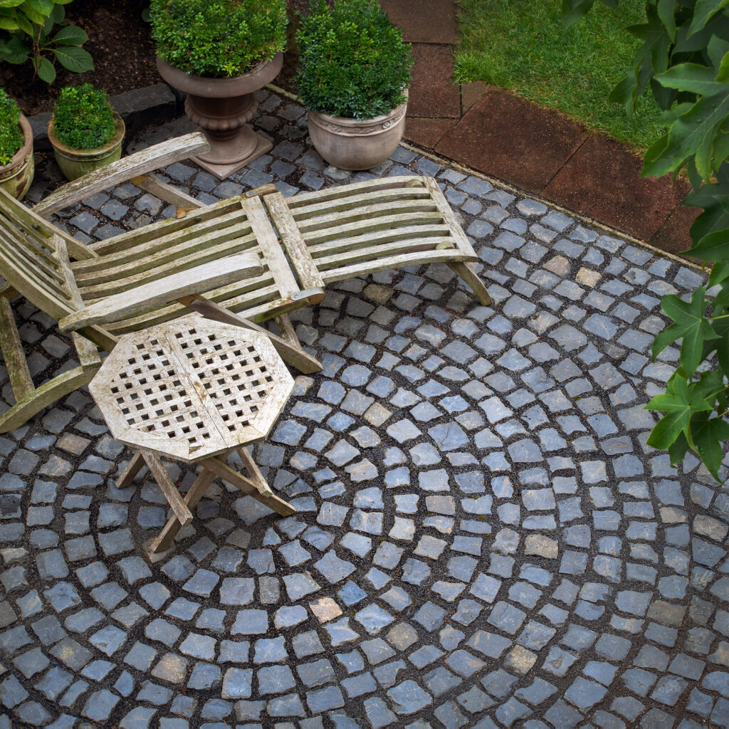 mit Natursteinen gepflasterter Bereich  in einem Garten